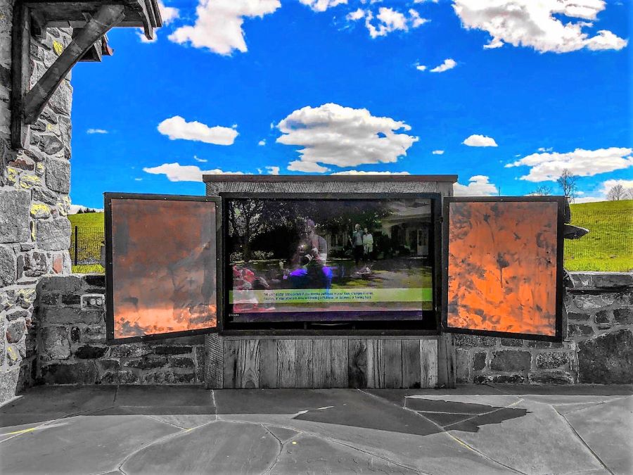 Rustic outdoor entertainment area with hills in the background.