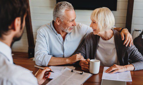Older couple and professional contractor discussing plans, selling scope in project proposals