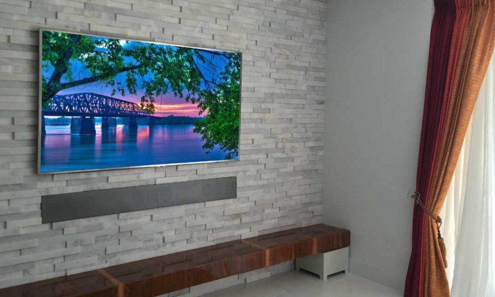 AV display and soundbar on marble wall. AV Design Concepts