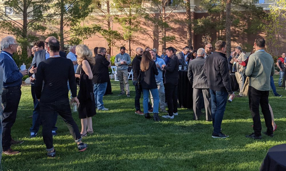 Attendees at 2023 HTSA Spring Conference gathered on lawn at JW Marriott Resort and Spa Las, Vegas for networking event and happy hour.