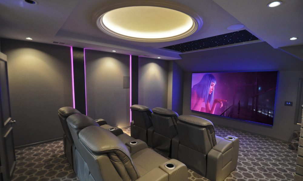 Interior of family-friendly entertainment room in converted attic space. Home theater design by Theater Advice