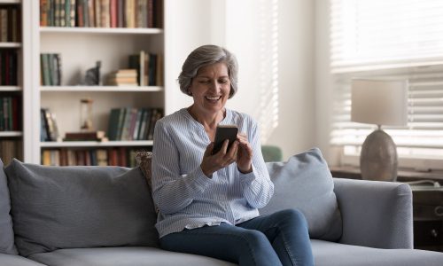 Senior living environment with individual on phone meant to represent environment and people that will be helped by new ASID guidance.