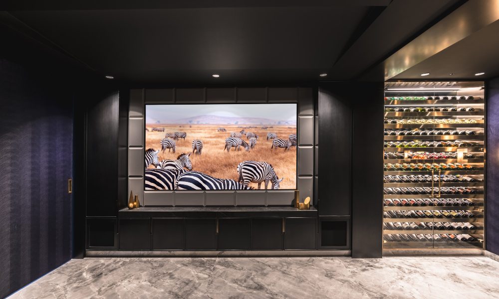 Home theater designed by Life Style Store next to wine cabinet in basement area of Sydney home.