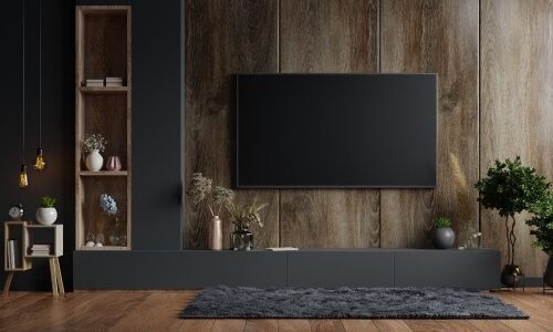 Mockup a TV wall mounted in a dark room with a dark wood wall.3d rendering