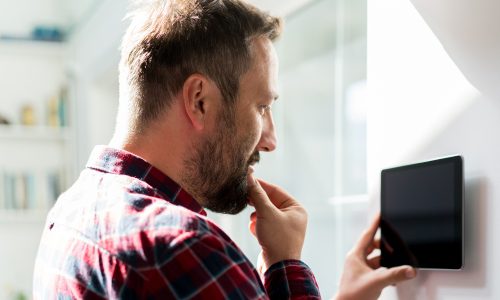 Man working on smart home device to highlight increased adoption rates