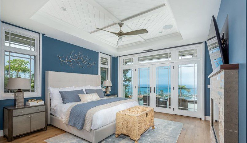 Bedroom, coastal blue designs, Coastal Point, California, angled wall-mounted TV over fireplace.