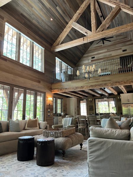 Interior, large lodge-like building with high chalet-style framing in living area with custom automated shading in Killen, Alabama