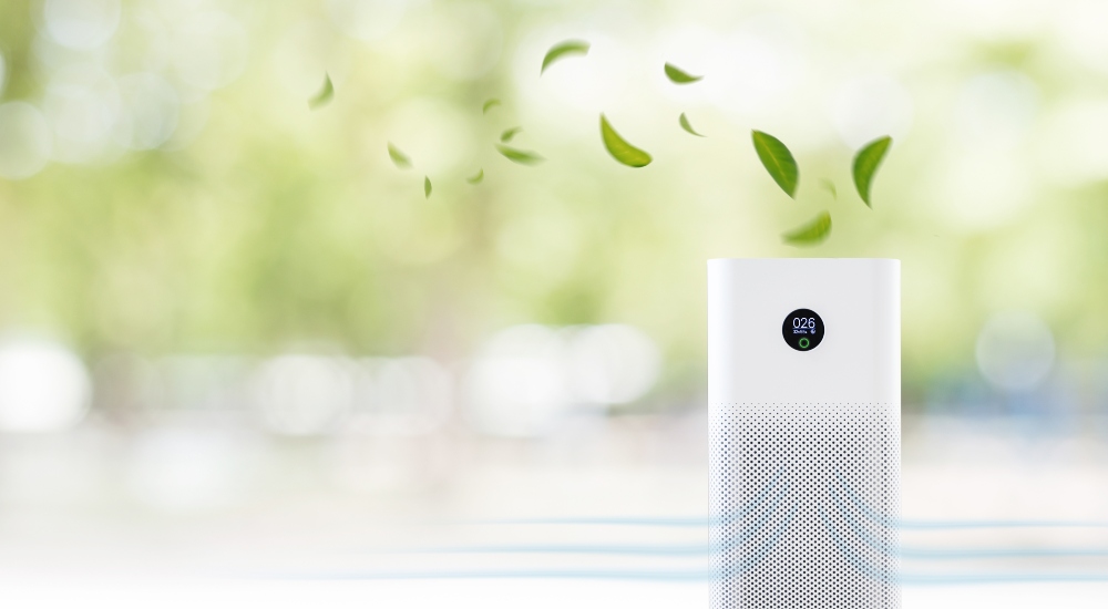 air purifier a living room, air cleaner removing fine dust in house. protect PM 2.5 dust and air pollution concept meant to represent number of wellness concepts popularized during COVID home wellness movement