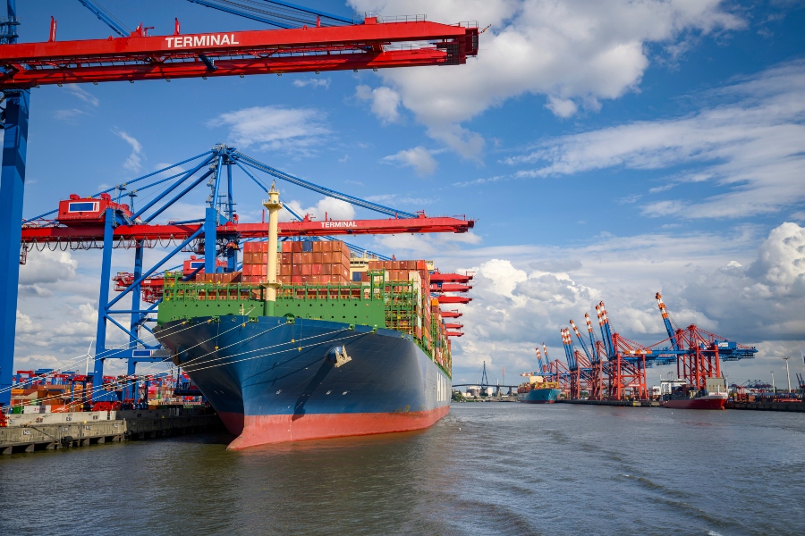 Shipping vessel at dockyard meant to represent global trade and tariffs