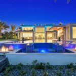 Luxury waterfront mansion in West Palm Beach featuring modern architecture, fire-lit pool design, and advanced home automation by ETC Florida.