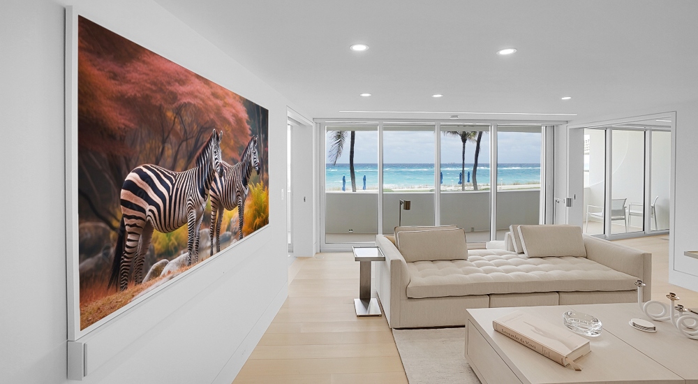 Living room in luxury Florida Atlantic Ocean condo with floor-to-ceiling windows showcasing panoramic ocean views and motorized shades.