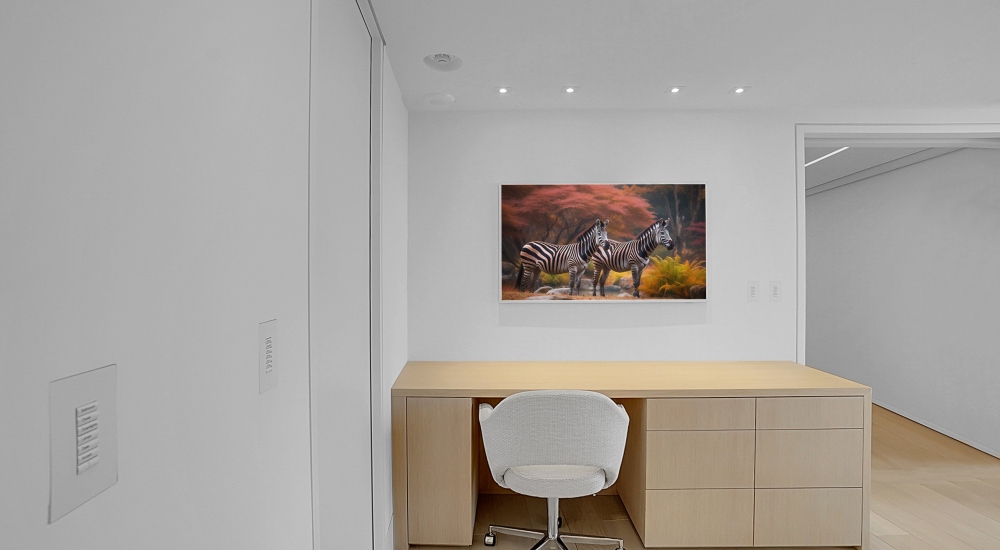 Bright office area in smart condo featuring white walls and natural wood paneling, designed for minimalist, light-filled workspace