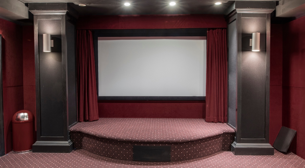 Interior of home theater in residential setting with blank screen meant to represent million dollar home theater demo coming to CEDIA Expo 2025