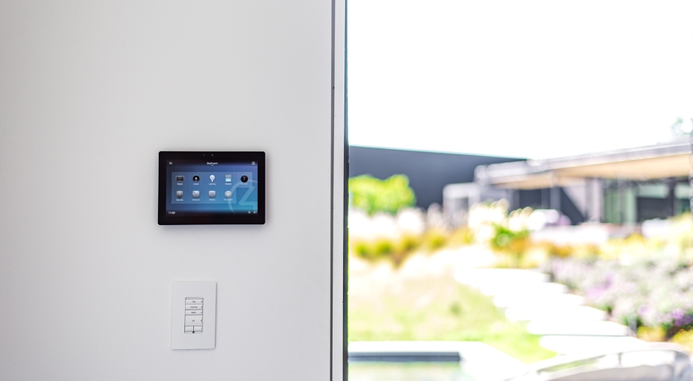 Control4 touch panel in Japanese-inspired smart home for managing audio, lighting, and security systems