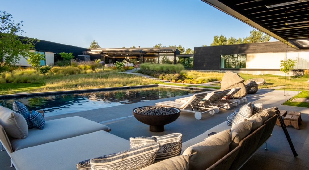 Smart home outdoor space with reflection pool and integrated landscape audio for immersive entertainment