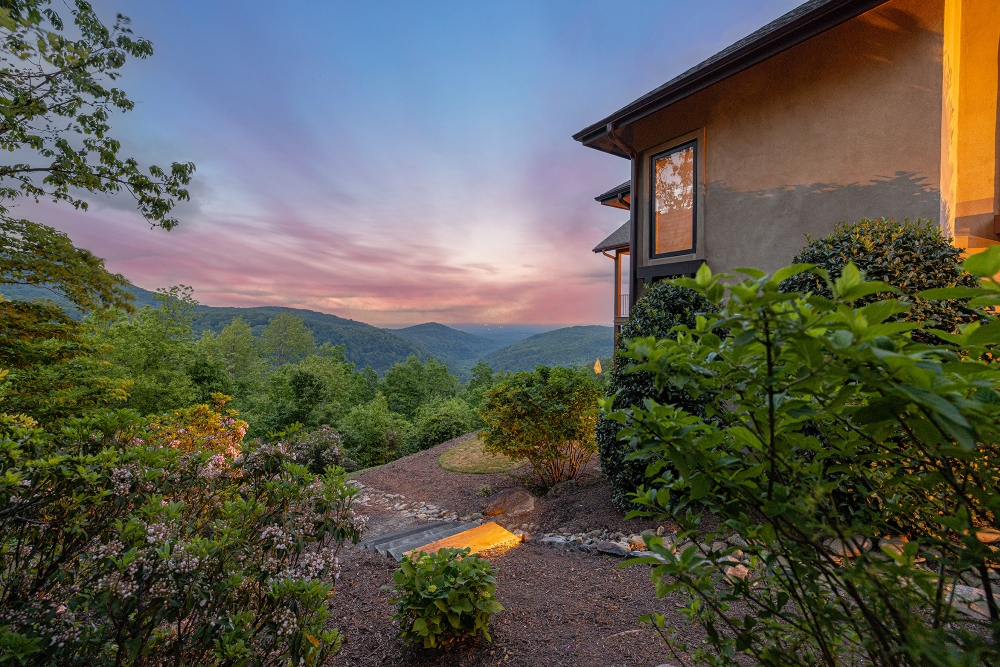 Night view of a North Carolina mountain home with glowing outdoor lighting
