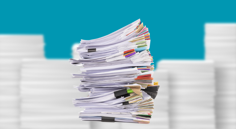 Stacks of paper to symbolize inefficient business processes.