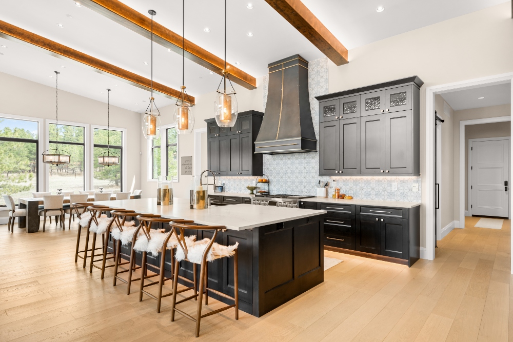 Layered lighting techniques applied in kitchen and dining room area.