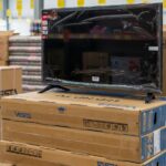 A TV on top of shipping boxes to represent global TV shipments in Q3 of 2025.