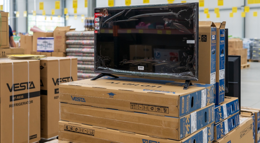 A TV on top of shipping boxes to represent global TV shipments in Q3 of 2025.
