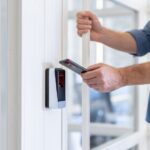 Man uses his smartphone to access a secure area, highlighting modern security technology and mobile access solutions affects by the Aliro 1.0 standard from the Connectivity Standards Alliance CSA