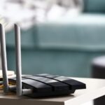 Modern consumer wi-fi router on table representing target of FCC ban on all foreign made routers