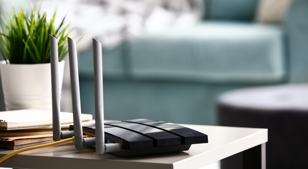 Modern consumer wi-fi router on table representing target of FCC ban on all foreign made routers
