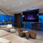 Motorized drop-down screen in Las Vegas penthouse home theater with skyline view behind screen