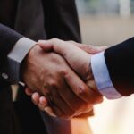 Business partner handshake meant to represent topic in Week in Playback weekly news segment for custom integration