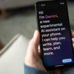 Individual opening Google Gemini on their smartphone, meant to represent the Gemini AI assistant within the Google smart home platform