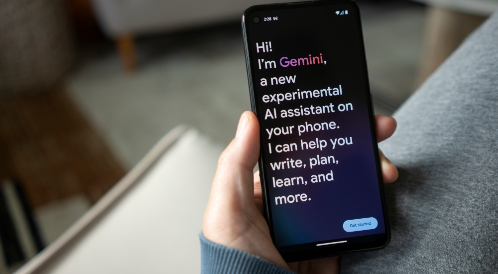 Individual opening Google Gemini on their smartphone, meant to represent the Gemini AI assistant within the Google smart home platform