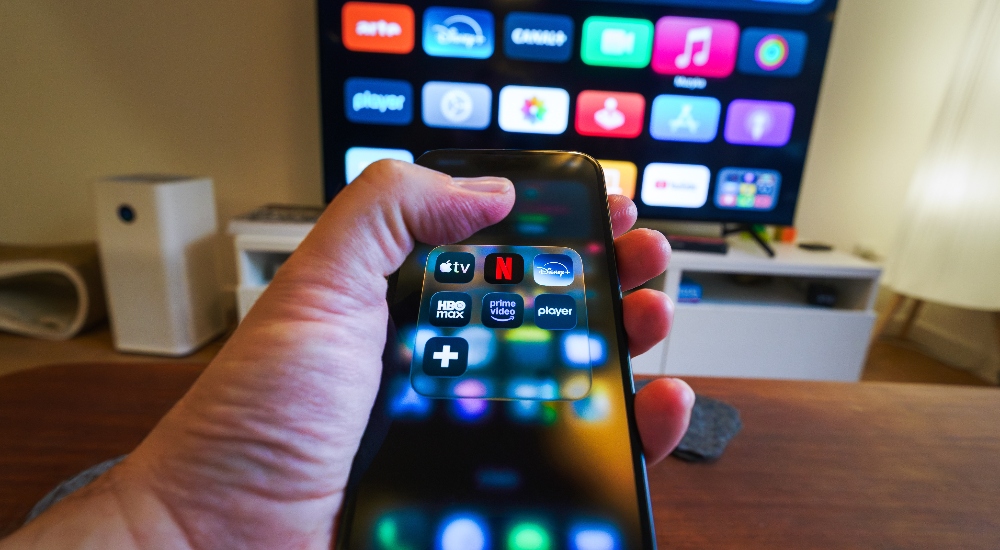 Man using Apple TV app in example of how he might use the new IC Realtime TV app