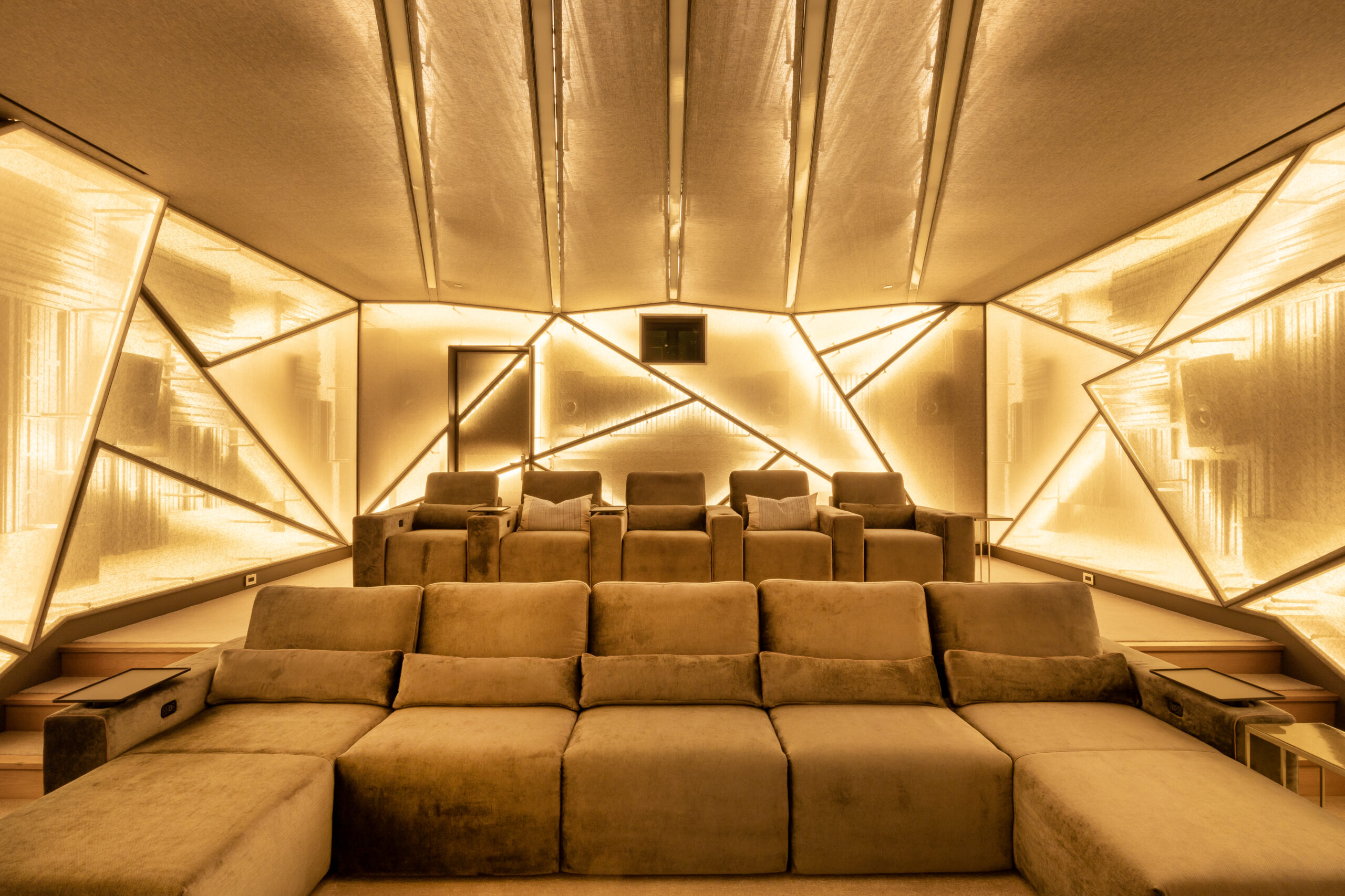 Wide view of a private home theater in a Palo Alto luxury residence featuring programmable yellow, purple, and white bias lighting with full Savant scene control, designed and installed by AudioVisions