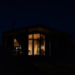 Homeowner bathed in warm lighting in cabin
