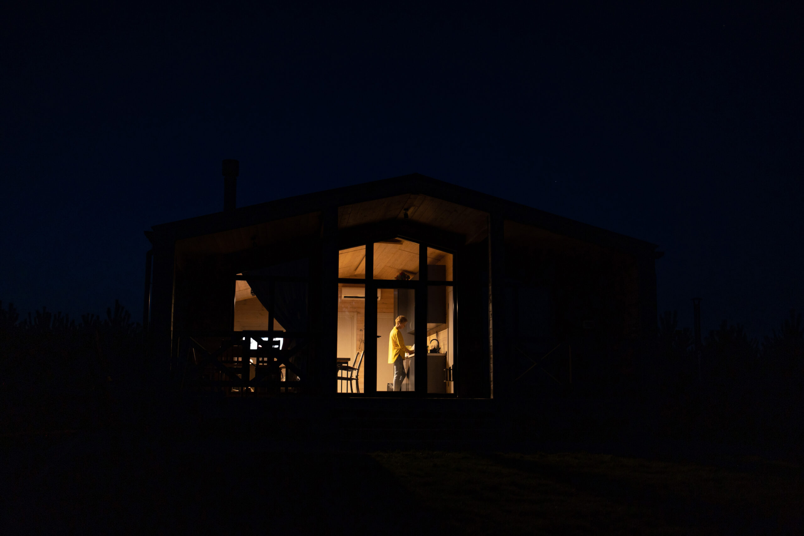 Homeowner bathed in warm lighting in cabin